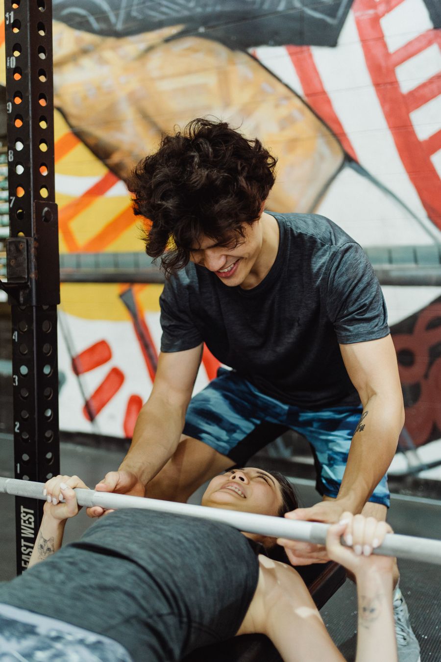 A training partner spotting a person performing a bench press
