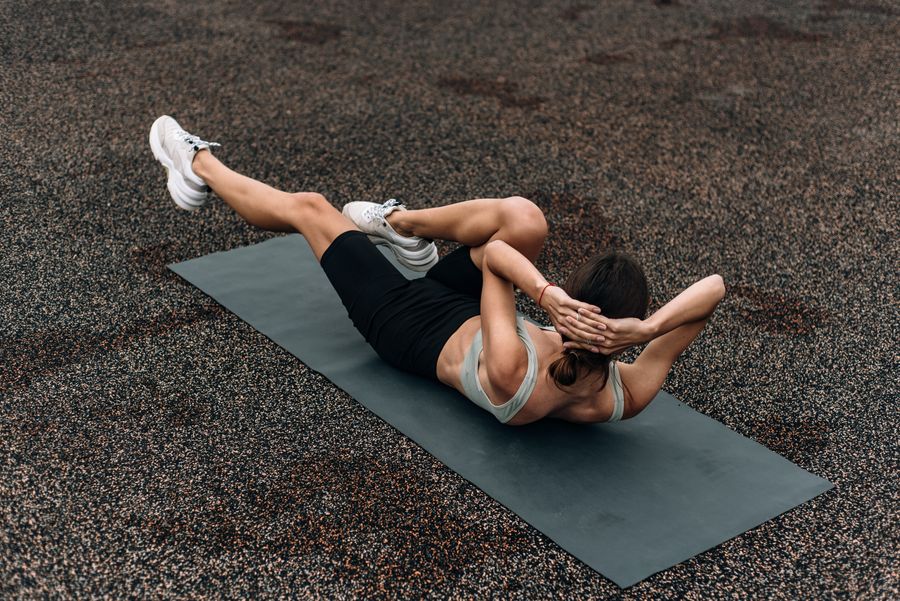 Person exercising on a thick exercise mat