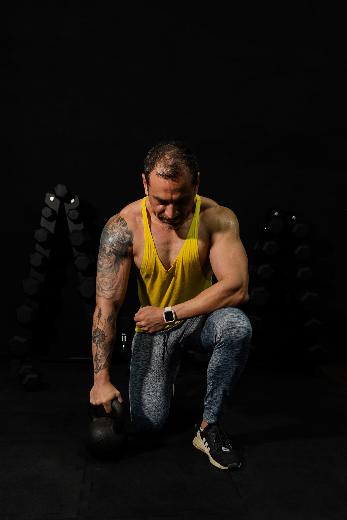 Person training with a kettlebell in a focused gym setting